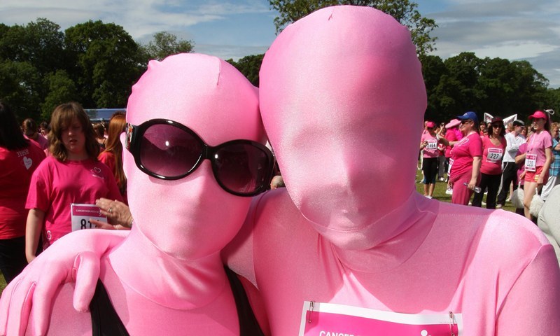 Kris Miller, Courier, 20/06/10, News. Picture today at Race for Life event, Camperdown Park, Dundee. Runners and walkers enjoyed a fun filled atmosphere and glorious weather for the Sunday event. Pic shows Sarah Laing and Katie McGuire in special pink morph suits.