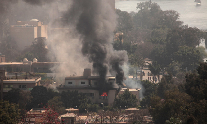 Smoke and fire rises from the Egyptian Soccer Federation after protesters set fire following a court verdict in Cairo.