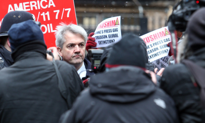 Chris Huhne arriving amid a media scrum outside Southwark Crown Court in London this morning.
