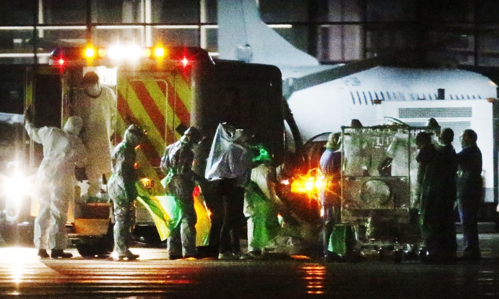 A healthcare worker is taken from an ambulance and transferred to a plane at Glasgow Airport as she is moved to the Royal Free Hospital in London, after being diagnosed with Ebola after returning from Sierra Leone. PRESS ASSOCIATION Photo. Picture date: Tuesday December 30, 2014. See PA story HEALTH Ebola. Photo credit should read: Danny Lawson/PA Wire