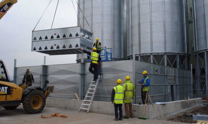 Construction workers assembling the new drier.
