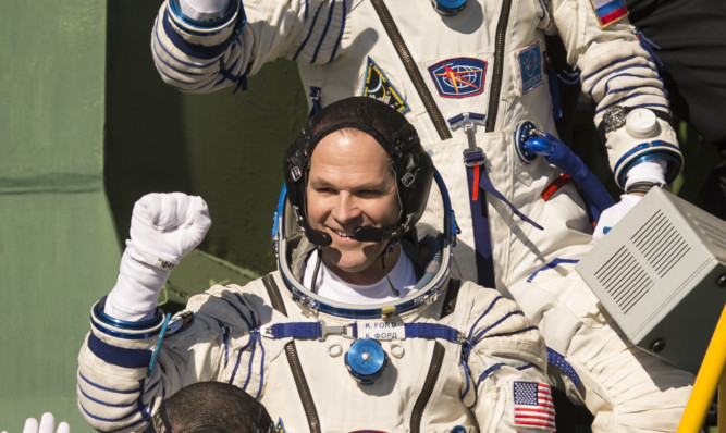 Kevin Ford waving farewell before boarding a Soyuz rocket to fly to the International Space Station on last October.