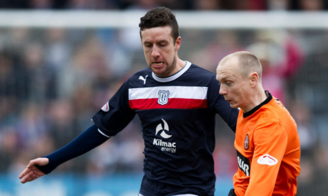 Dundee's Ryan Conroy clashes with Dundee United's Willo Flood in the last derby meeting.