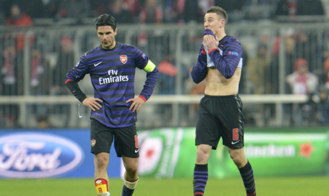 Arsenal's Mikel Arteta (left) and Laurent Koscielny are disappointed to go out after an impressive win in Germany.