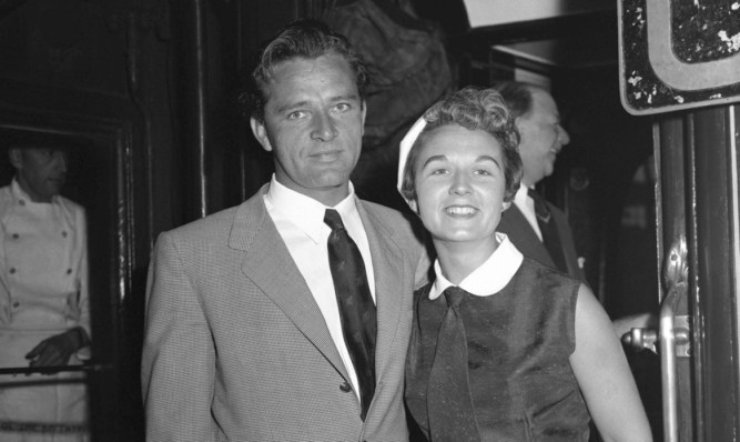 Sybil Williams Burton and her husband, actor Richard Burton, pose for a photo at Victoria Station in London.