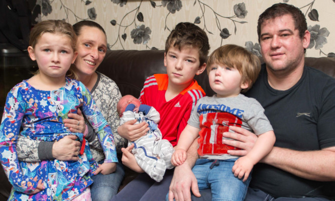 From left: Nicole, mum Fiona, Thomas with New Years baby Zac, Dale and dad Thomas.