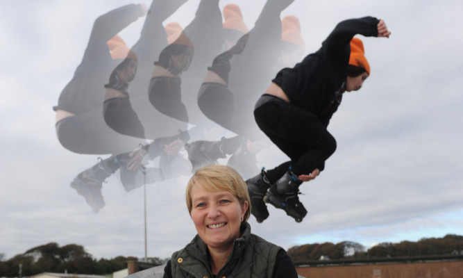 Jillian Low at the skatepark, with her son Michael clearing one of the jumps behind her.