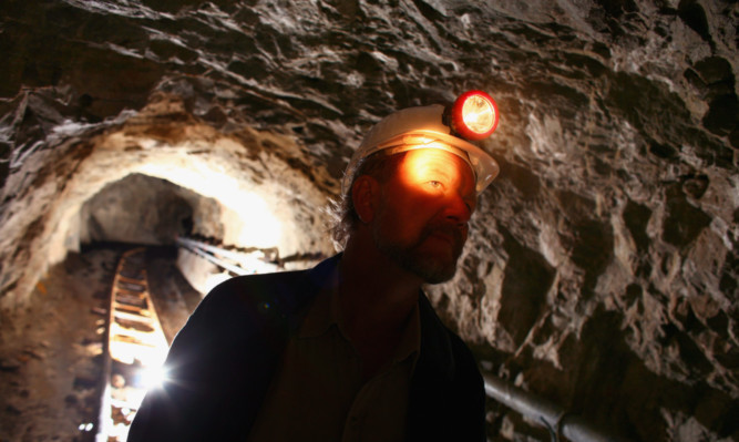 Chris Sangster, chief executive of Scotgold, inspects the mine near Tyndrum.