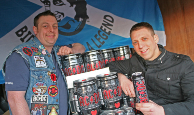 Above  John Crawford (left) and Courier reporter Graeme Bletcher with the imported AC/DC beer.