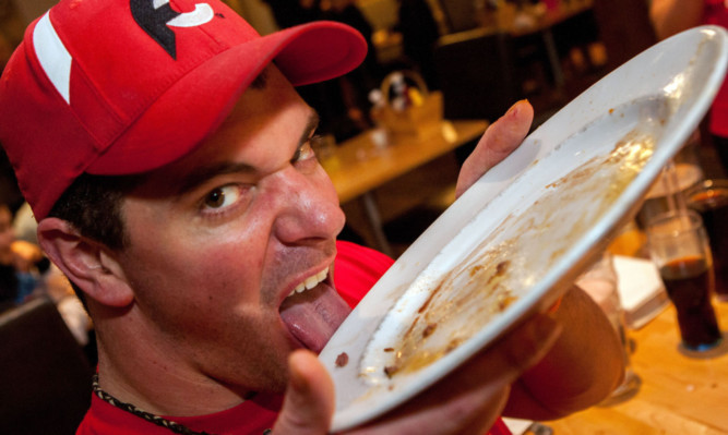 Randy Santel licks his plate clean.