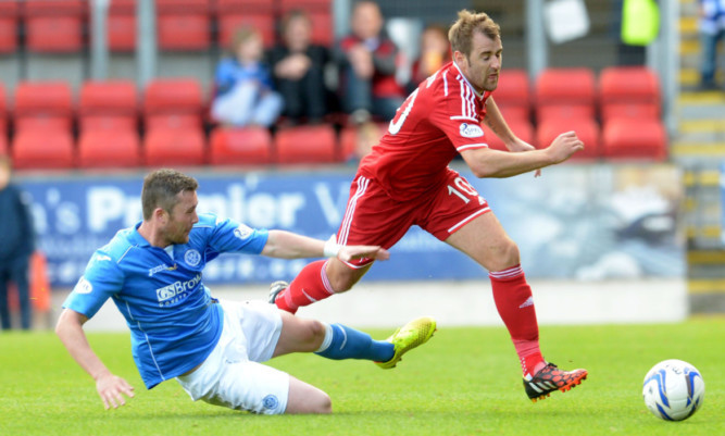 St Johnstone's Tam Scobbie (pictured left) in action.