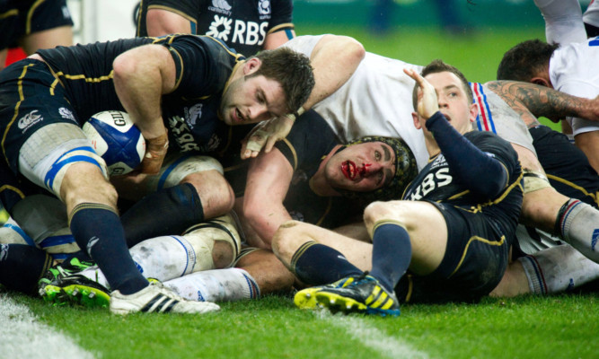 Total commitment in the ruck from 
Scotland's Kelly Brown.