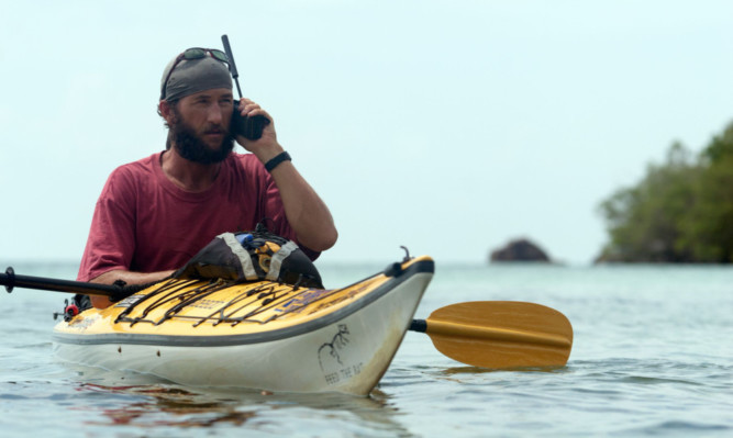 Jason Lewis takes to the water during his travels.