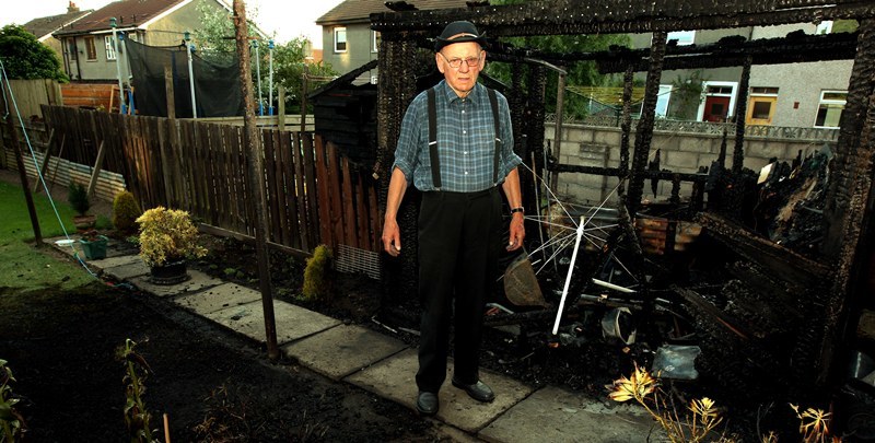 John Stevenson, Courier,22/06/10.Dundee.Barbecue fire,Pic shows Mr William Robertson of 139 Fintry Drive in whats left of his garden and shed after the barbecue destroyed them.