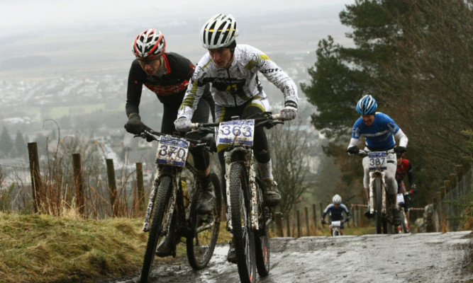 Some of the competitors reach the top of the hill.