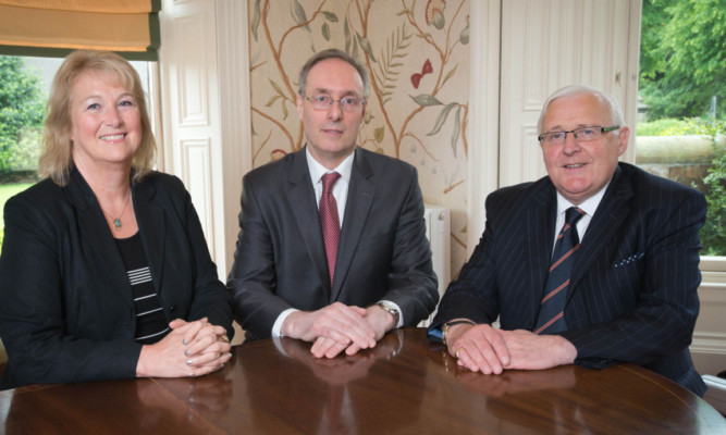 Hilary Eldridge of Steel Eldridge Stewart, John Leith of Murray Donald, and Jack Robertson of Thorntons seal the merger.