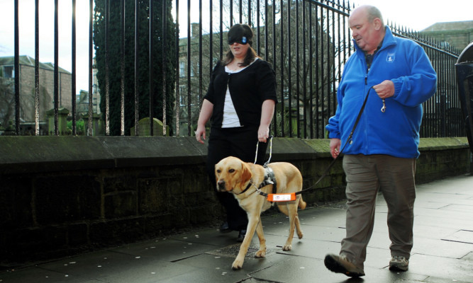 Kirsty Topping and Logan Anderson with Guide Dog George.