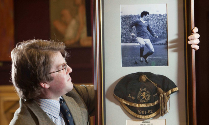 Valuer Hamish Wilson with a Scotland international cap given to late Rangers footballer Jim Baxter in the 1960s.