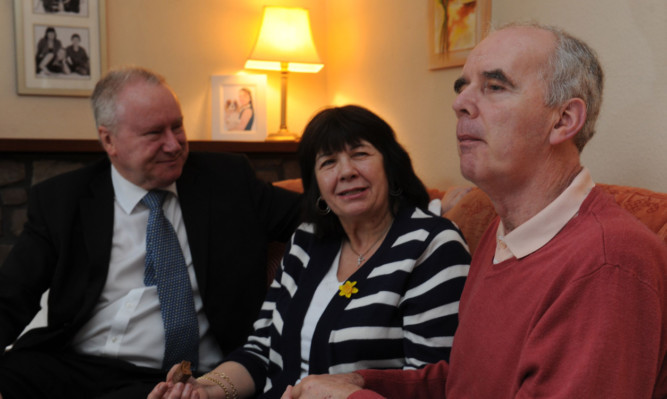 Amanda Kopel with her husband Frank, right, when former Health Secretary Alex Neil visited the couples Kirriemuir home in March last year.