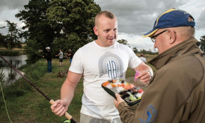 A Castle Huntly inmate selects a fly during the fly-fishing course.