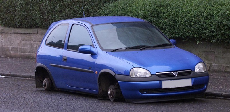 Vauxhall Corsa with missing wheels in Clepington Road, Dundee.