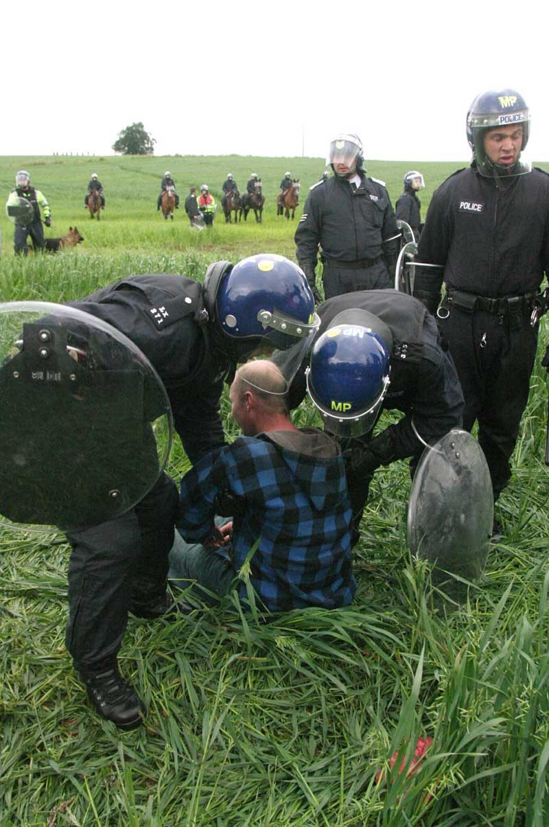 COURIER, DOUGIE NICOLSON, 06/07/05, NEWS.
G8 PROTEST MARCH, ORCHIL ROAD, A/ARDER.
One protestor is dragged out of the field.