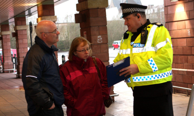 Police talk to shoppers outside Morrisons in Arbroath.