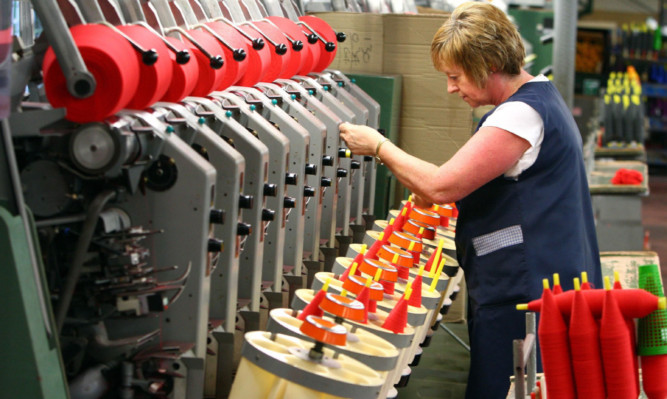 A worker involved in the cashmere yarn manufacturing process at Todd & Duncan of Kinross. Scotlands private-sector economy ended the year on a sound footing.