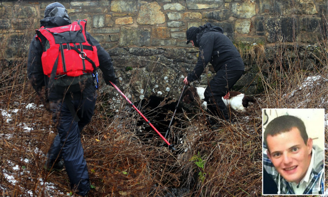 Graham Clyde and Iain Marshall with dog Barra as they search ground in the Holl reservoir area for Allan Bryant Jr, inset.