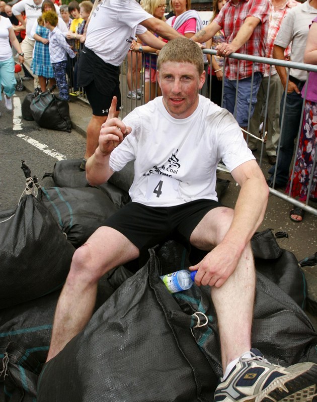 Gareth Jennings,Sunday Post....Winner of the " Scottish Coal Carrying Championships " in Kelty, 26 year old Johnny Sinclair from Cowdenbeath, words Paul , Dunfermline.