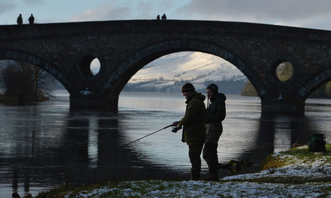 An angler casts during a previous season opening day at Kenmore.