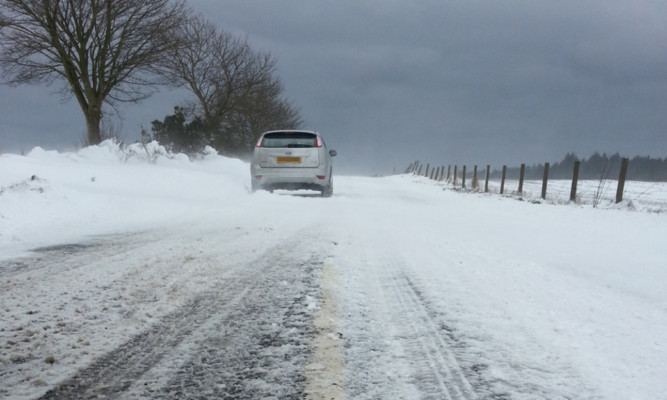 Difficult conditions on the B9128 Carnoustie to Forfar road near the Crombie crossroad on Friday.