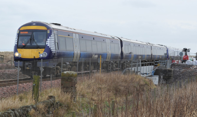 Kim Cessford - 27.12.12 - pictured is a train crossing the newly replaced railway bridge over the Elliot Burn at Arbroath