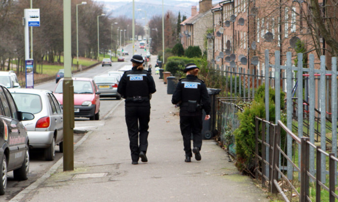 Police carry out inquiries on South Road, Charleston.
