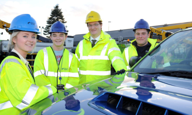 Danny Alexander at SSEs Inverness office. His visit came as the Perth-based utility accepted a £1.118bn funding proposal for a project that will deliver the most significant upgrade in decades to Scotlands rural electricity network. Mr Alexander, second from right, is seen with Laura Sneddon from Falkirk, Scott Shade of Camelon and Josh Hardy from Beauly.