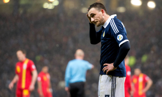 Dejection for Scotlands Robert Snodgrass after receiving a red card and conceding a penalty against Wales at Hampden.