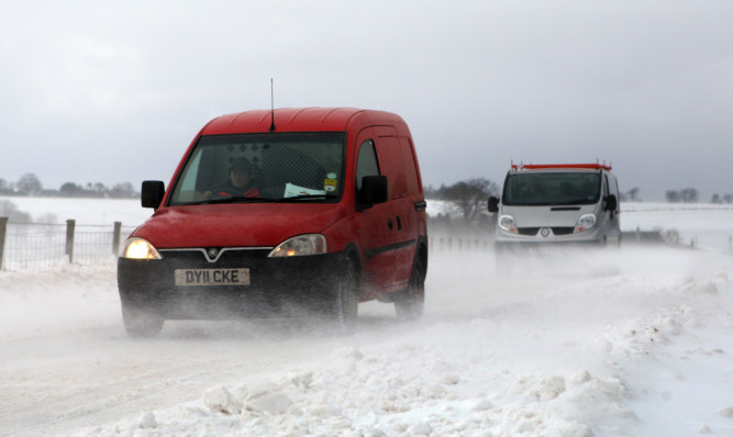 Kris Miller, Courier, 22/03/13. Picture today shows drivers trying to get through some of the deep snow drifts on the B961 as drifting snow and high winds caused chaos on the roads.
