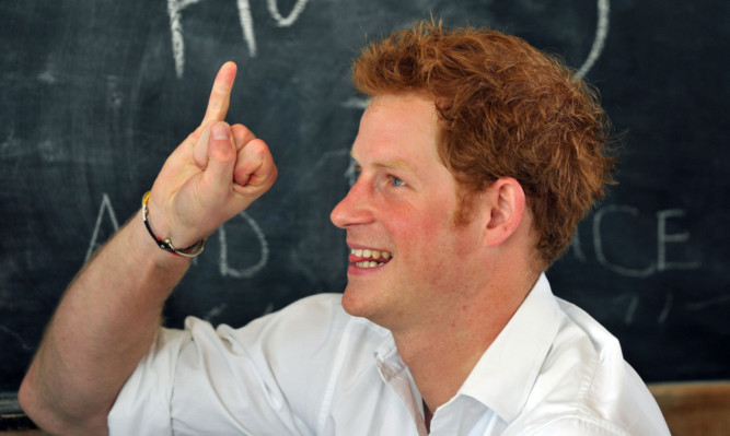 Prince Harry tries his hand at sign language in a class at the Kananelo Centre for the deaf, in the Mesaru district of Lesotho in south Africa, where the Prince saw the continuing work of the Sentabale Charity he set up in memory of his mother Diana, with Prince Seeiso of Lesotho. PRESS ASSOCIATION Photo. Picture date: Wednesday February 27, 2013. See PA story Prince Harry, Sentable Charity. Photo credit should read: John Stillwell/PA Wire