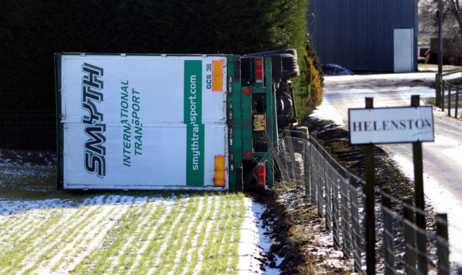 The lorry lying on its side at Helenston Farm. The HGV has been lying there since last week when it was toppled.