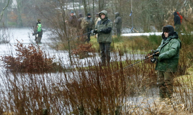 Anglers enduring some tough conditions on the first day of the Tay salmon fishing season last week.