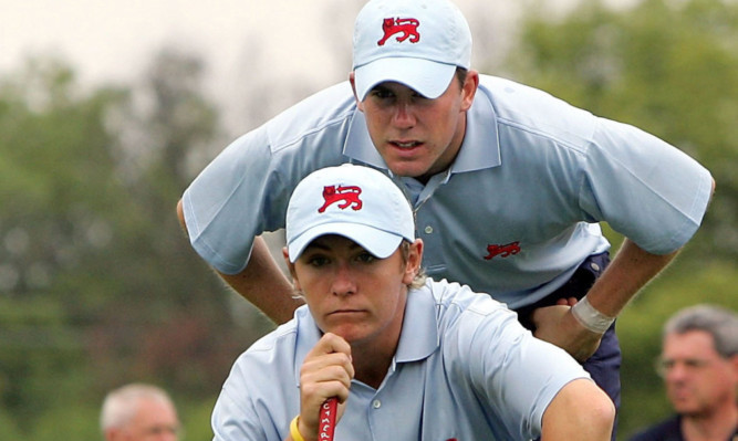 Lloyd Saltman (front) lines up a putt with Richie Ramsay at the 2005 Walker Cup match in Illinois.
