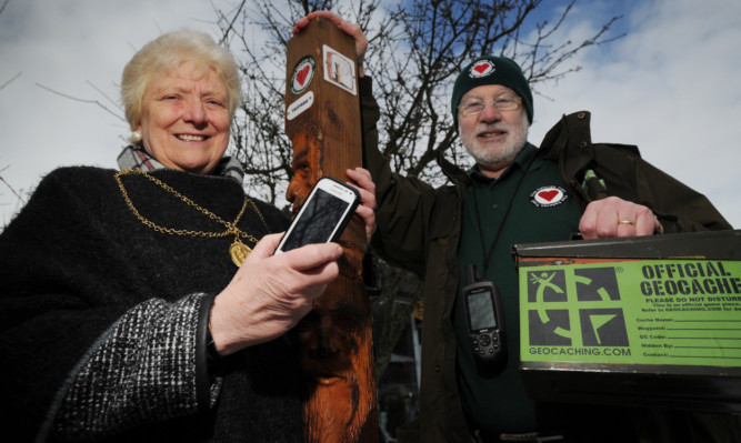 Provost Liz Grant and Bepta chairman Councillor Bob Ellis with one of the trail marker posts and geocache boxes.