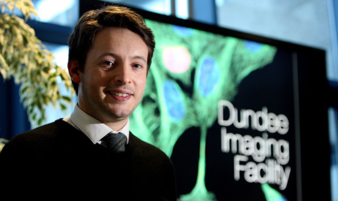 Fraser Milne, whose image of a microscopic meteorite was the overall winner of a competition to mark the opening of the imaging facility.