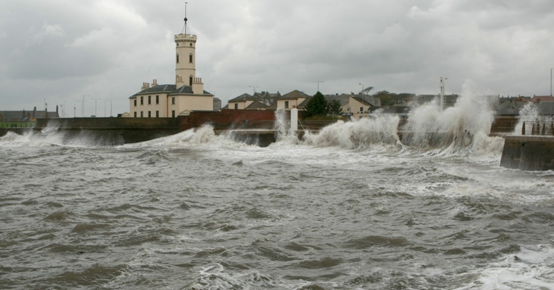 Waves crashing over the breakwater at Arbroath harbour at the Signal Tower Museum.