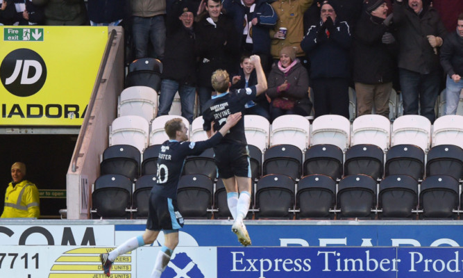 Gary Irvine (right) leaps intop the air after scoring.