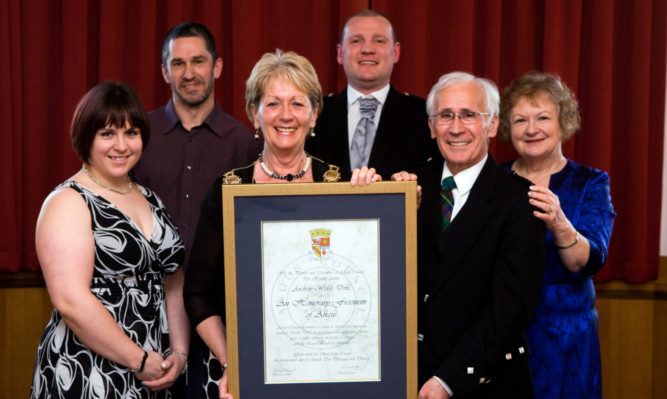 Provost Helen Oswald and Andrew Welsh hold the framed certificate. Also pictured are (from left) Mr Welshs daughter Jane Smith, nephew Gary Ferguson, son-in-law Roly Smith and wife Sheena.