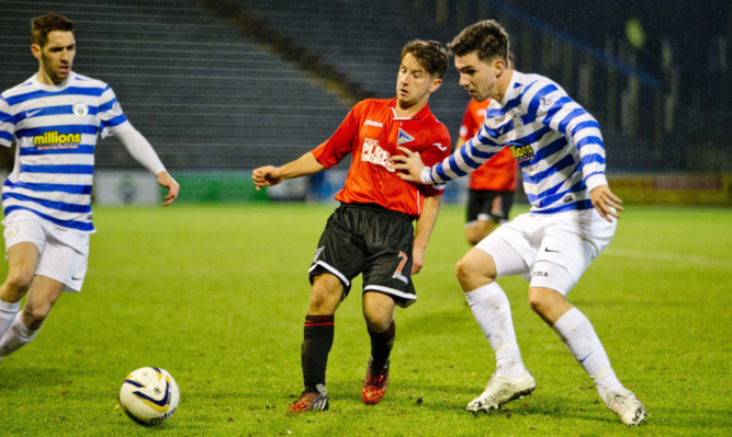 Dunfermline captain Josh Falkingham is shoved off the ball as the Pars try to find a way past the Morton defence.