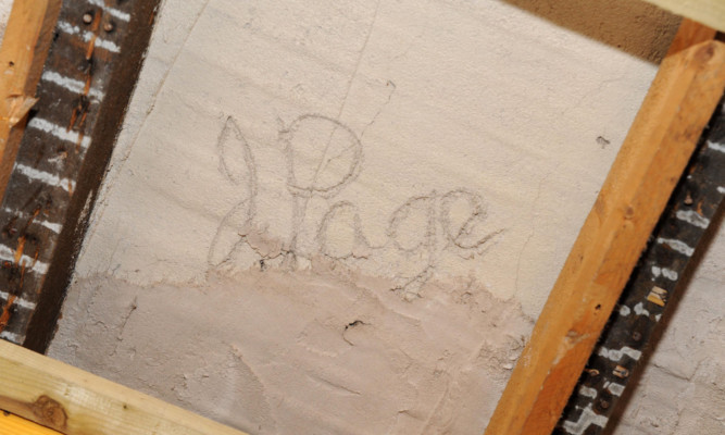 One of the names found carved into the building's plaster.
