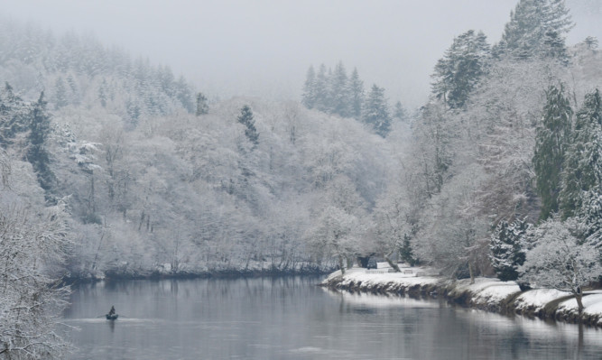 Kim Cessford - 15.01.13 - pictured is the snowy scene of the River Tay at Dunkeld with a fisherman braving the cold at the start of the fishing season