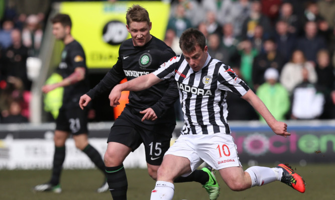 St Mirren's Paul Mcgowan holds off Celtic's Kris Commons.